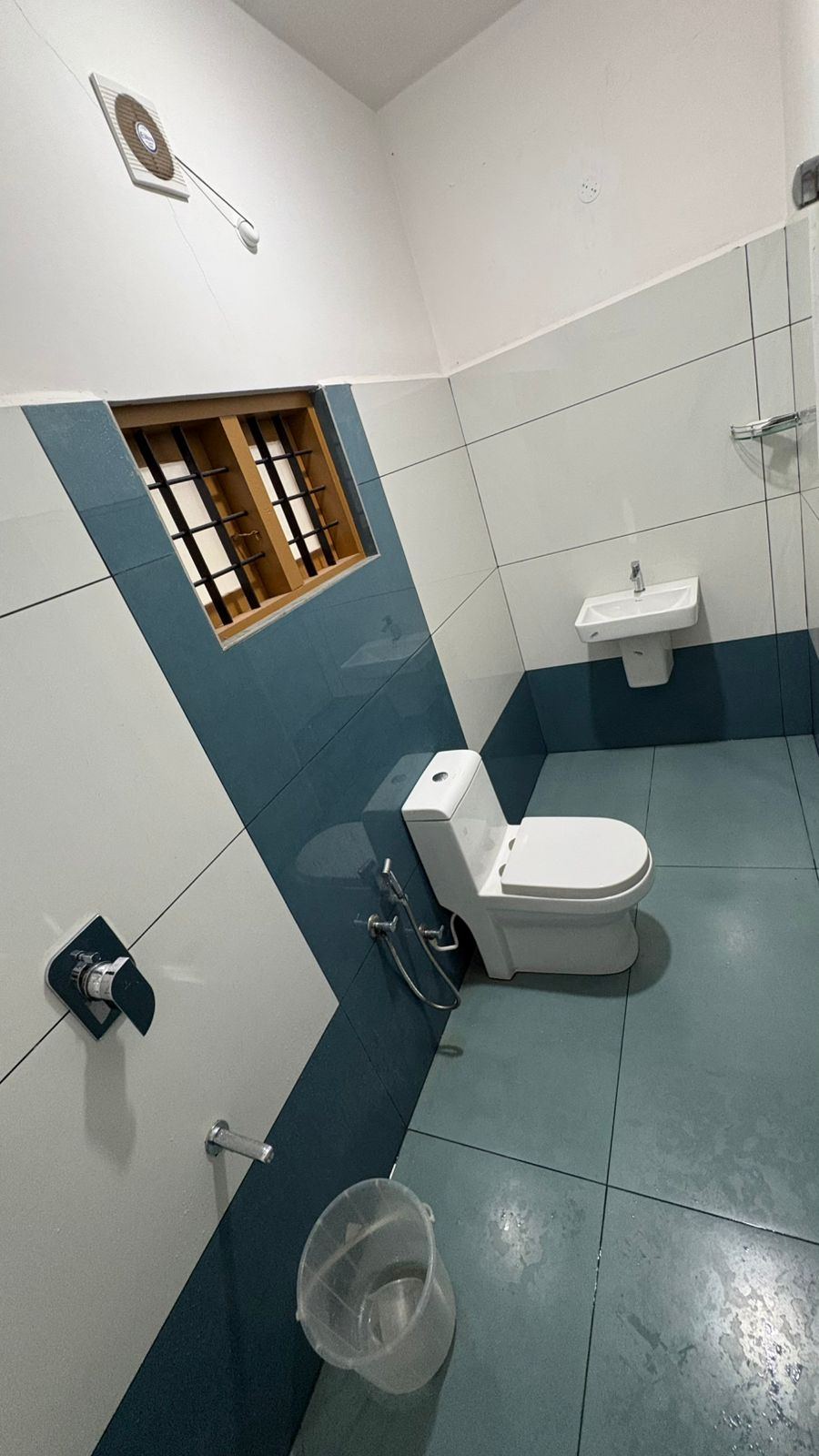 Bathroom shower area with blue tiling